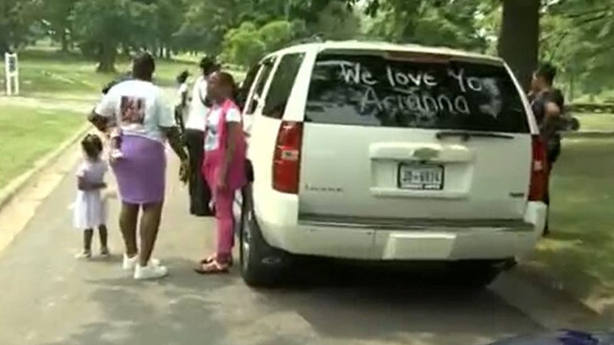 An SUV with we love you arianna written on back