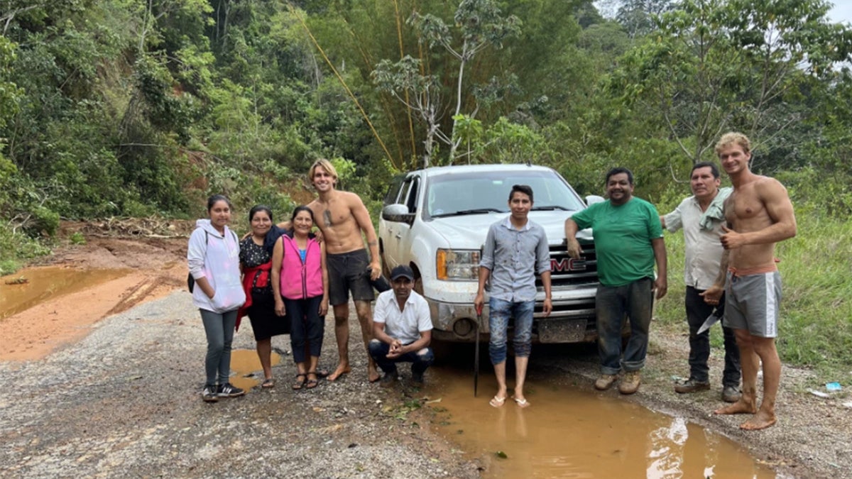 Daniel Penny shown shirtless with a group of locals on a roadtrip in South America.