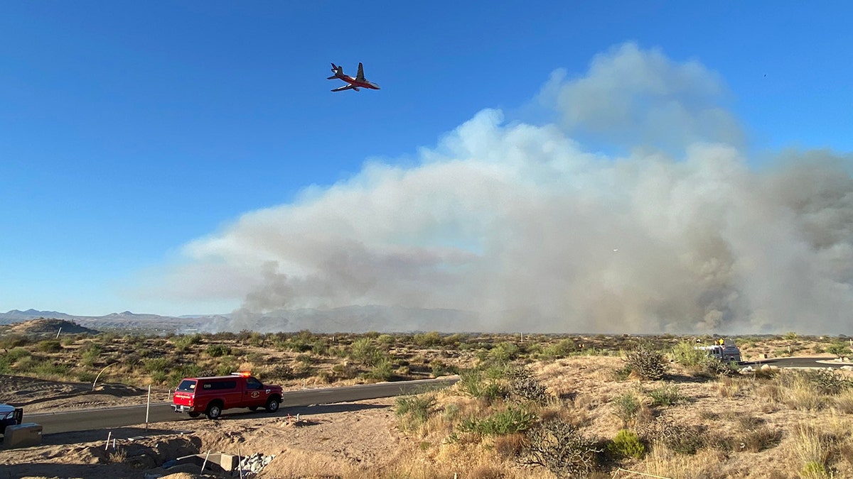fire plane flying over smoke