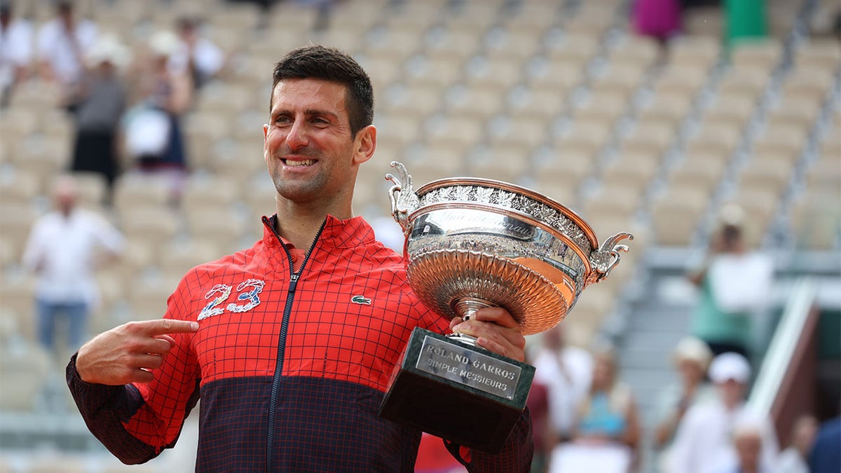 Novak Djokovic celebrates with trophy