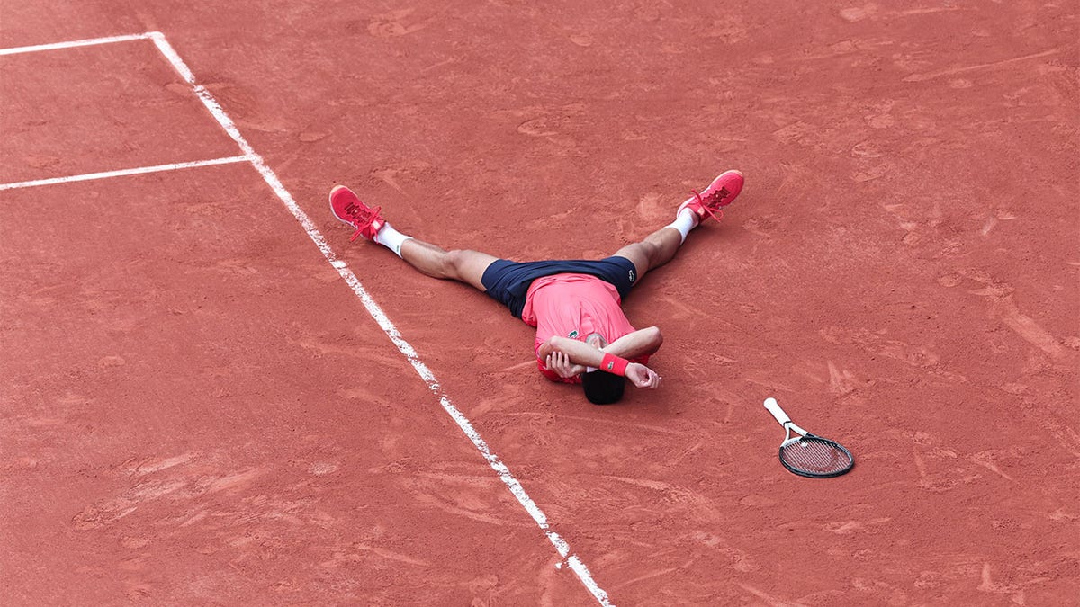 Novak Djokovic lays on ground