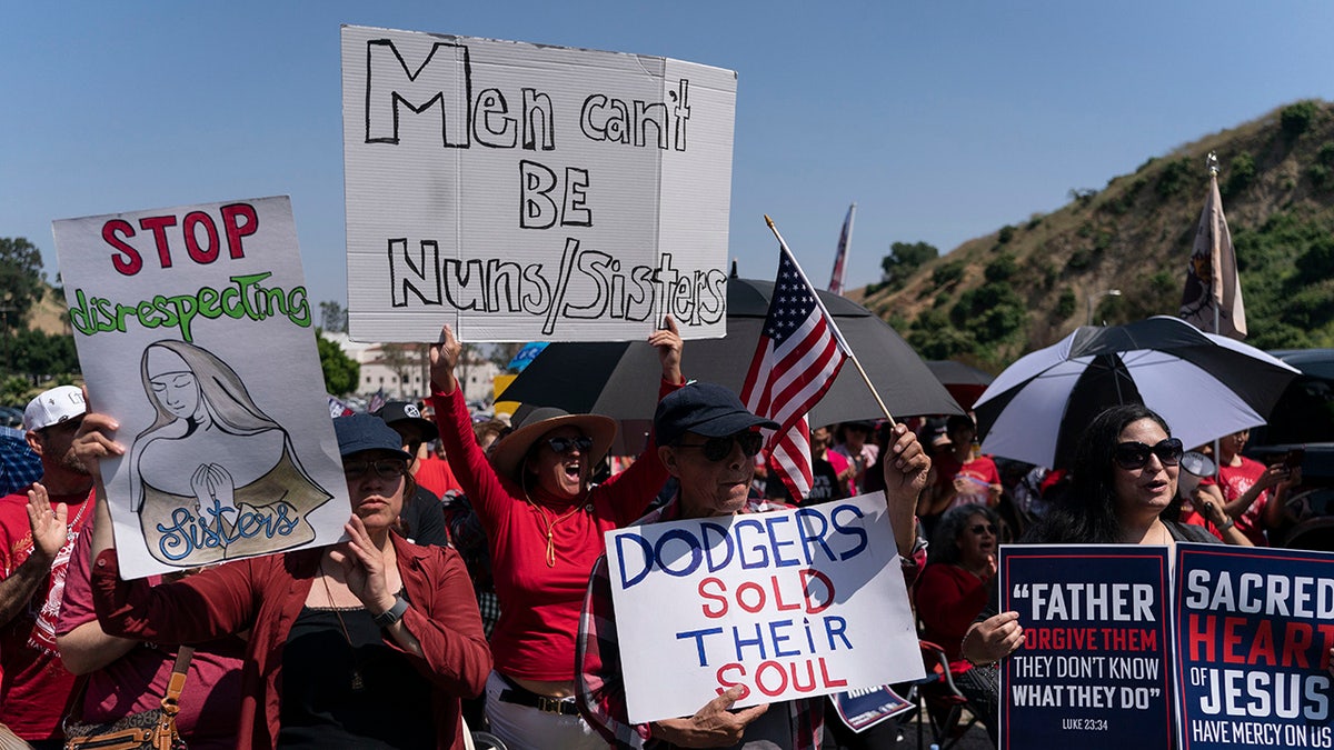 People hold signs during a prayer service