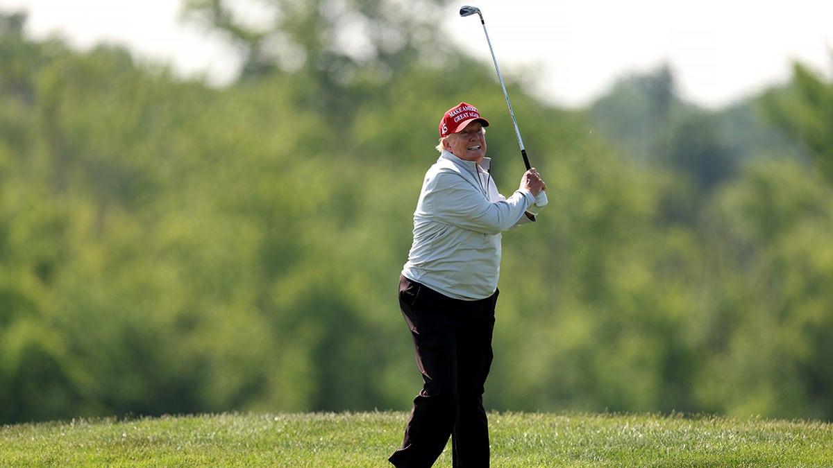 Donald Trump swings golf club