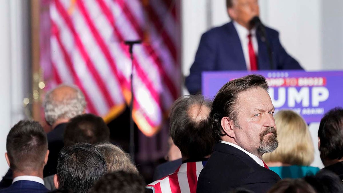 Sebastian Gorka looks behind him as former President Donald Trump speaks to supporters