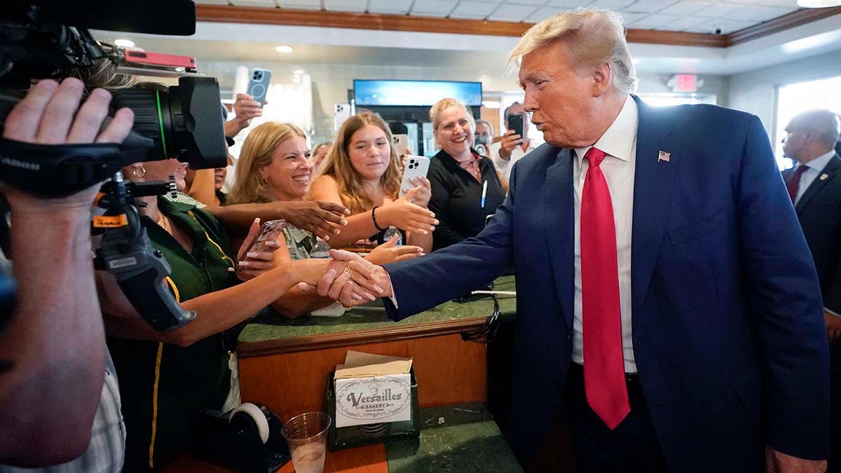 Donald Trump greets supporters at Versailles restaurant