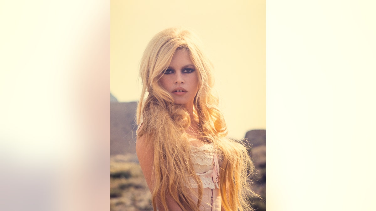 Brigitte Bardot wearing an ivory lace dress