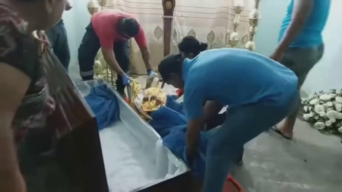 Ecuadorian woman lifted out of coffin after mourners discover she is alive