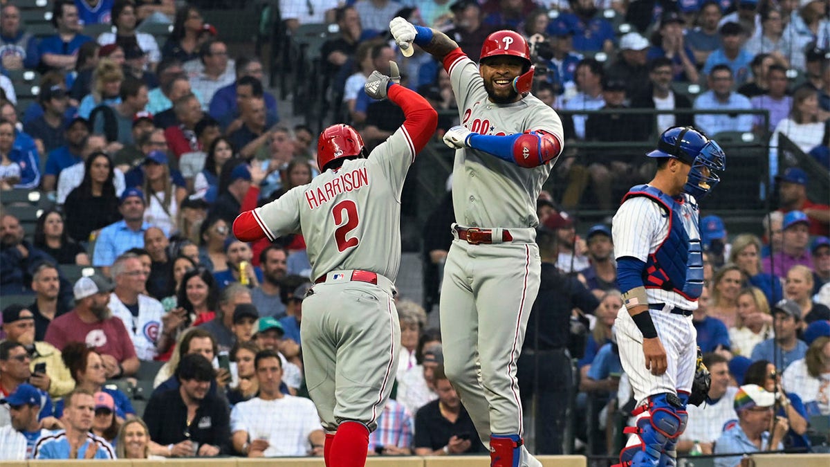 Edmundo Sosa and Josh Harrison celebrate