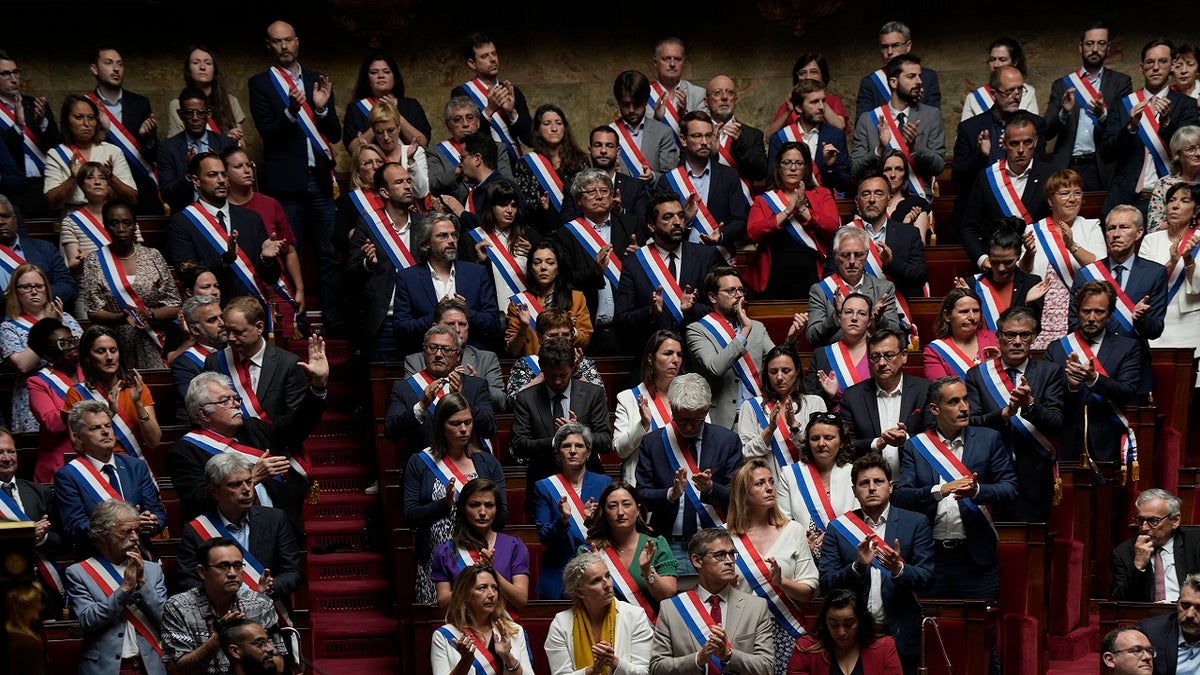 Lawmakers in France's National Assembly pay tribute to knife attack victims