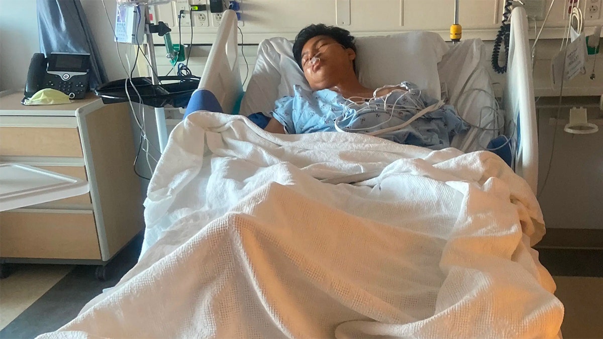Gelvy Ortiz lays in a Santa Monica hospital bed with one leg missing