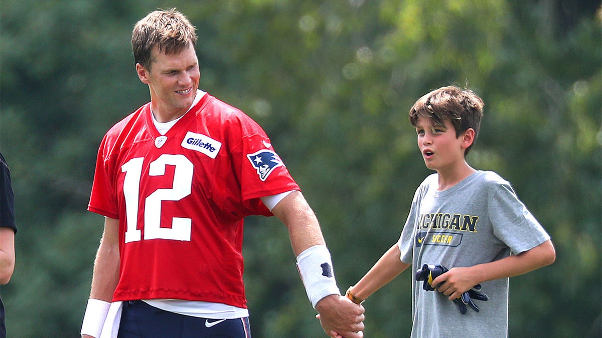 Tom Brady walks off the field with son, Jack