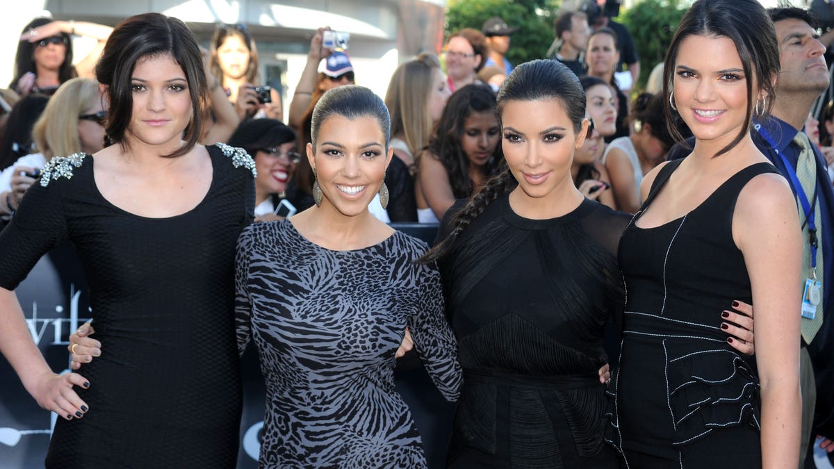 Kylie Jenner, Kourtney Kardashian, Kim Kardashian, and Kendall Jenner pose together on the red carpet