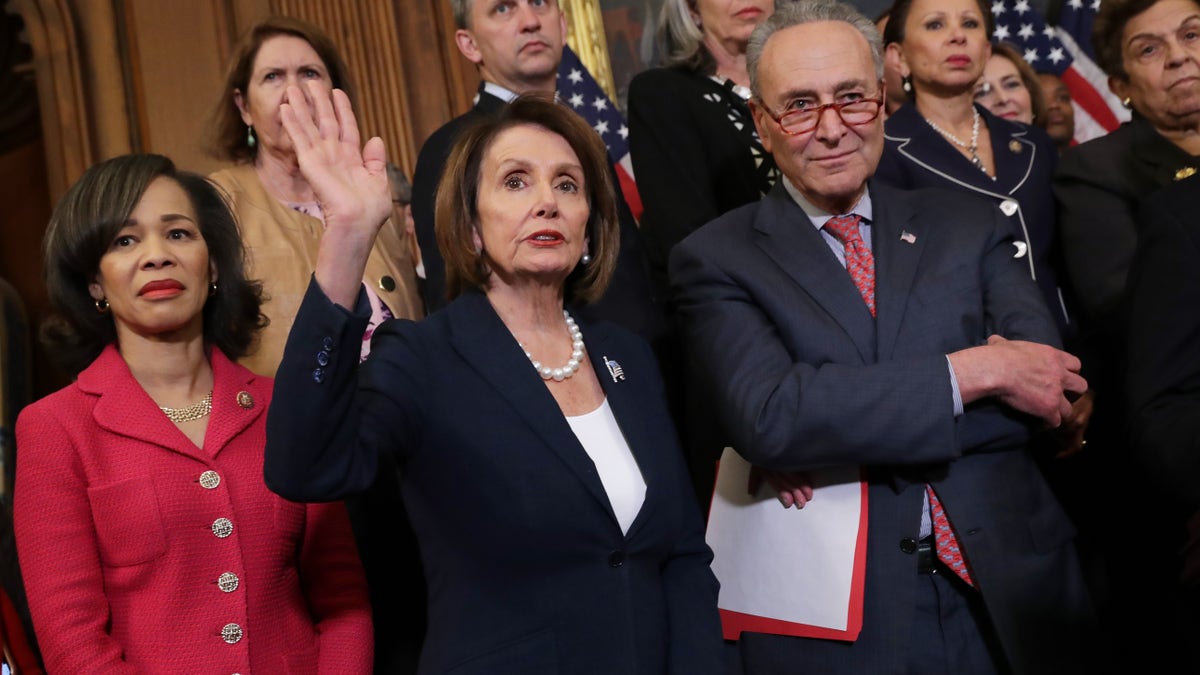 (L-R) Rep. Lisa Blunt Rochester, D-Del., Rep. Nancy Pelosi, D-Calif., Sen. Chuck Schumer, D-N.Y., and other congressional Democrats hold a rally and news conference ahead of a House vote on health care and prescription drug legislation in the Rayburn Room at the U.S. Capitol on May 15, 2019 in Washington, D.C.