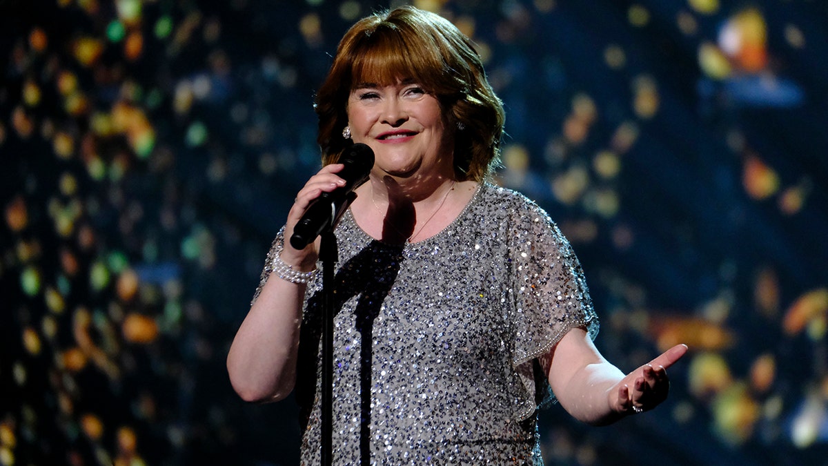 Susan Boyle in a sparkly short-sleeve dress sings on stage during "America's Got Talent"