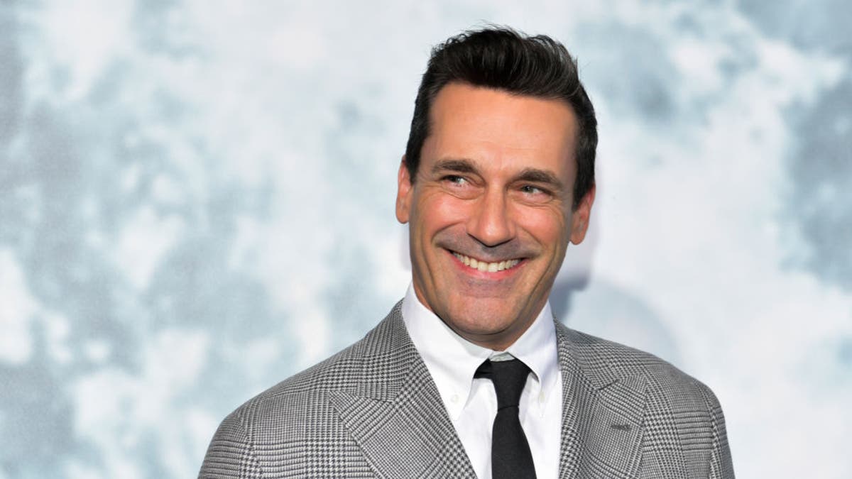 jon hamm smiling and looking off to the side
