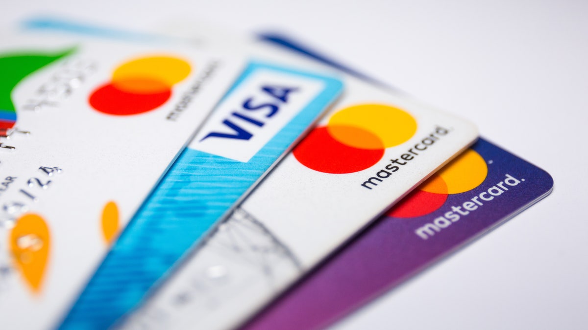 In this photo illustration a Visa credit card and Mastercard debit cards are seen displayed.