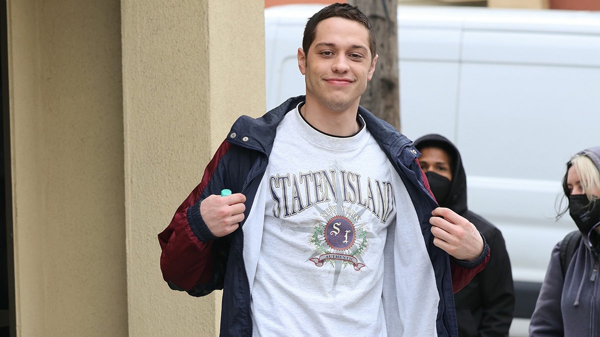 Pete Davidson flashes a Staten Island shirt on the set of his show "Bupkis"