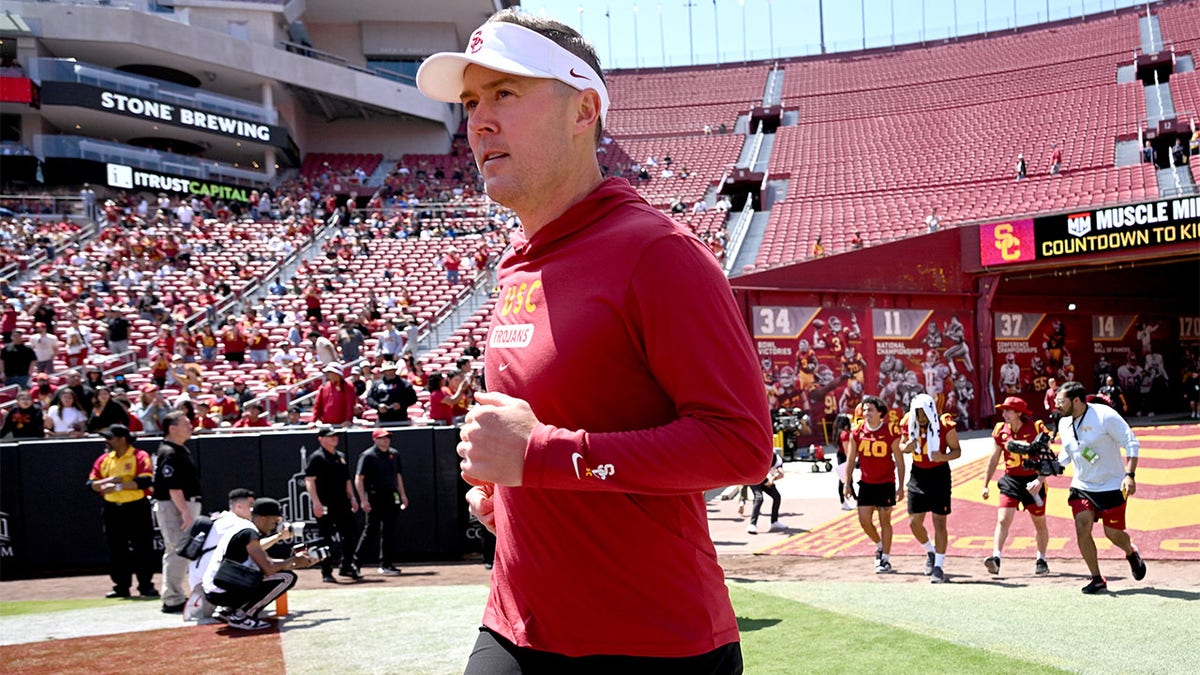 Lincoln Riley runs onto the field for the USC Spring Game