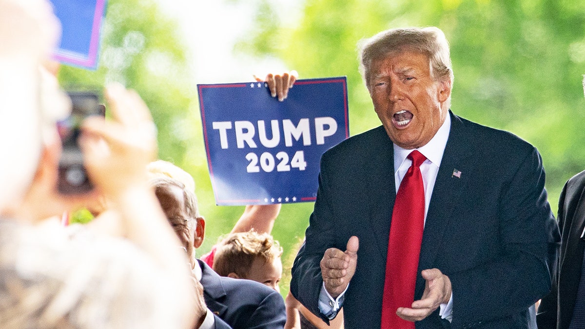 Former President Donald Trump arrives to meet with local Republican leaders at the Machine Shed restaurant in Urbandale, Iowa, on Thursday.