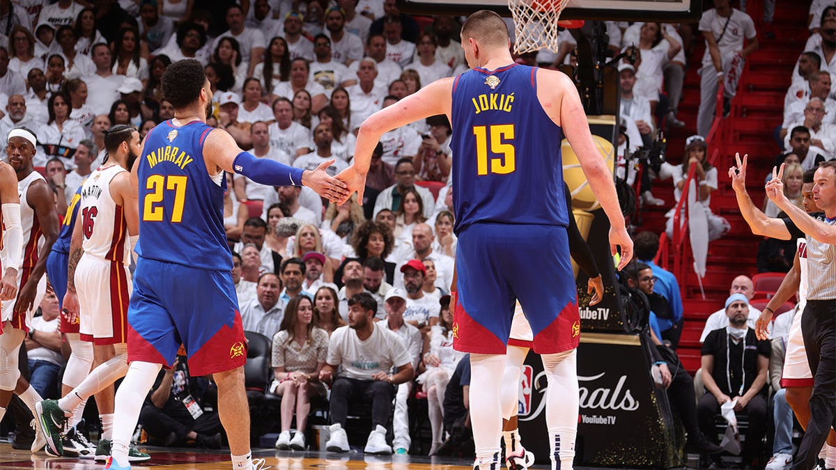 Jamal Murray high fives Nikola Jokic