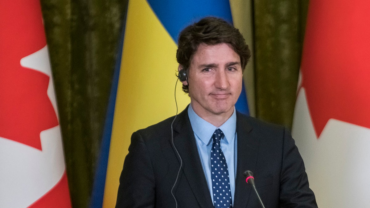 Justin Trudeau in front of Canada, Ukraine flags in Kyiv