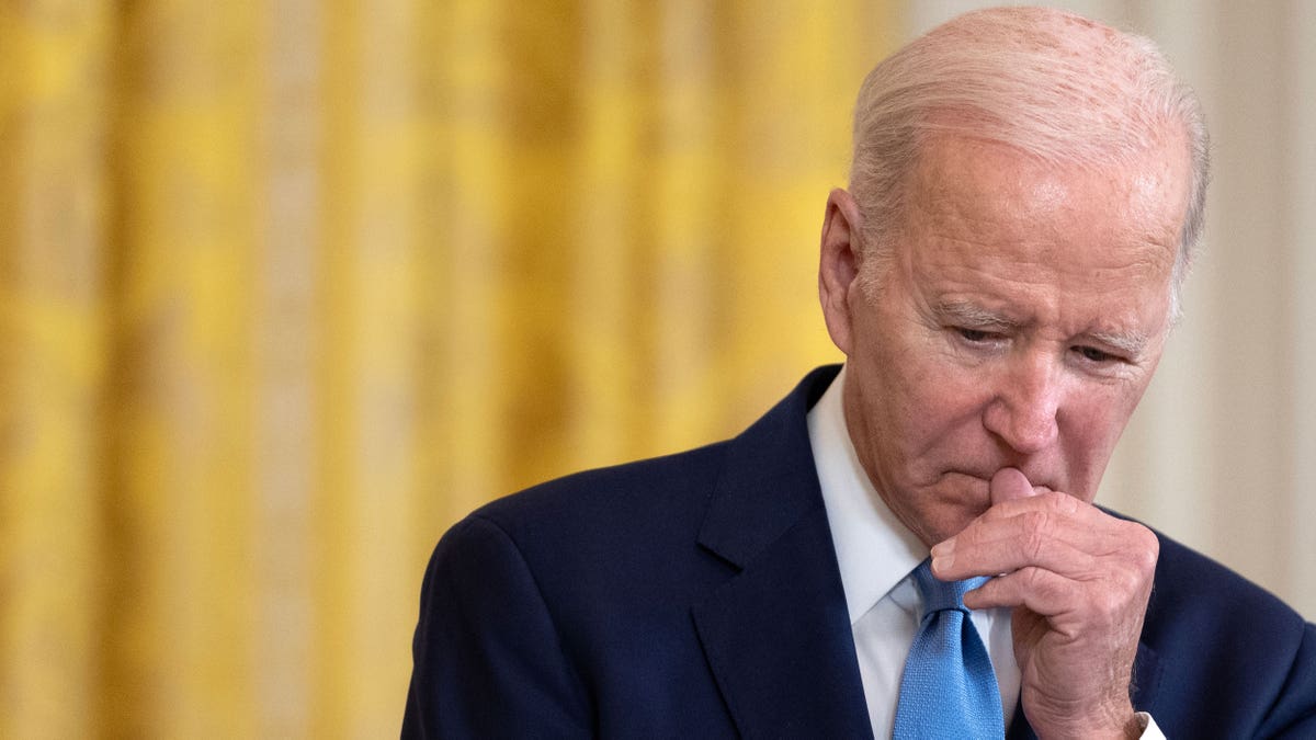 President Biden with hand to face
