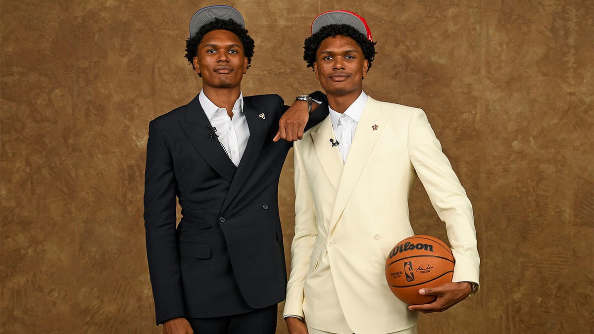 Amen Thompson and Ausar Thompson take a picture at the NBA Draft