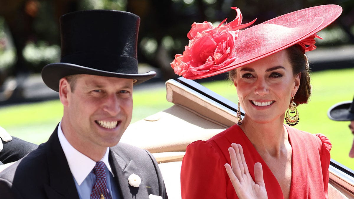 A photo of Prince William and Kate Middleton riding in a carriage