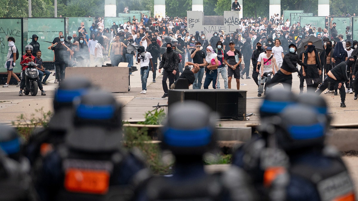 Protestors demonstrate in front of police