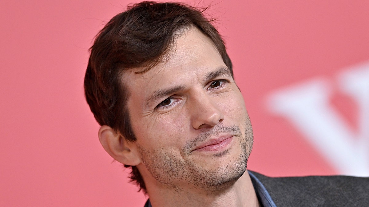 Ashton Kutcher soft smiles at the premiere of "Your Place Or Mine" in LA