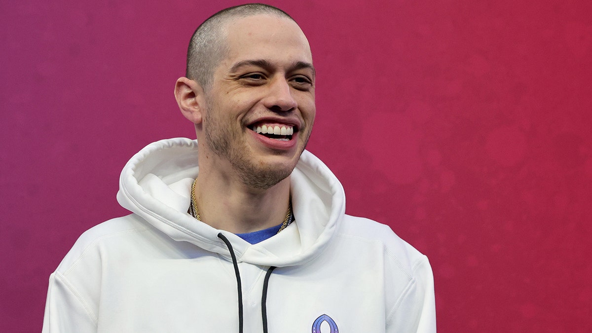 Pete Davidson smiles in a white sweatshirt In Las Vegas at the Pro Bowl Game