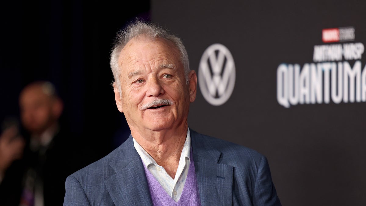 Bill Murray in a suit with a purple sweater