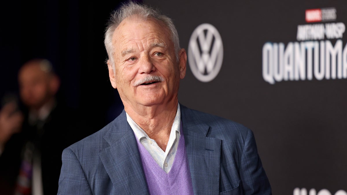 Bill Murray in a suit with a purple sweater