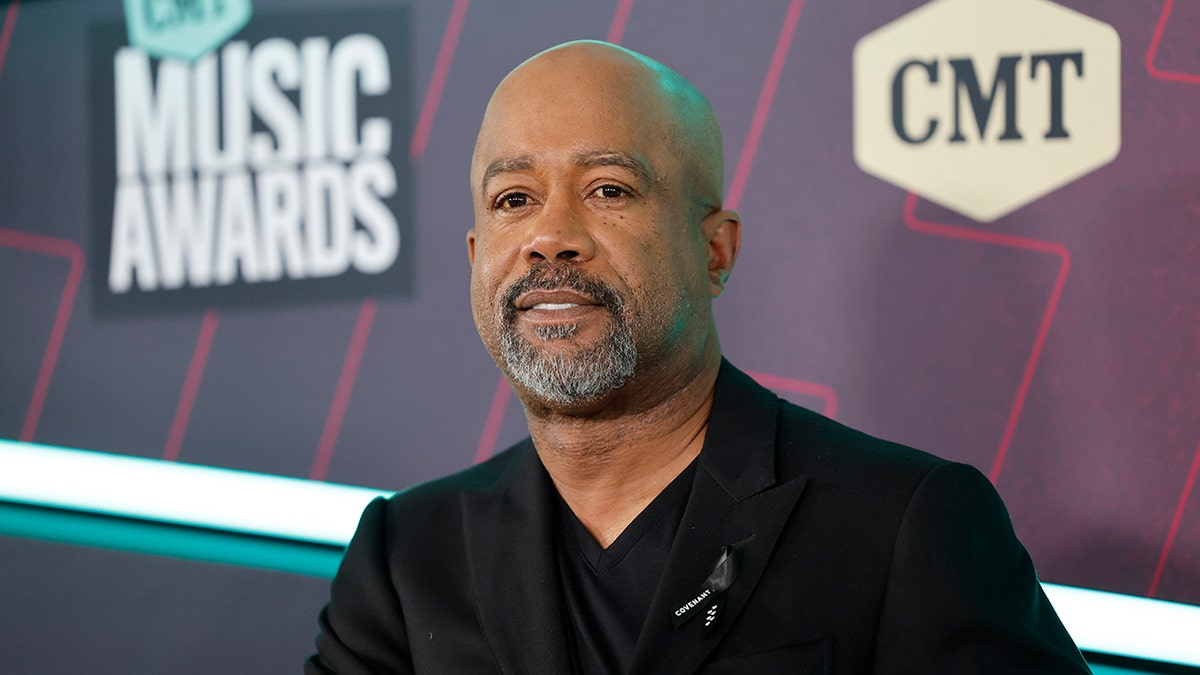 Darius Rucker in a black suit smiles at the CMT Music Awards in Austin