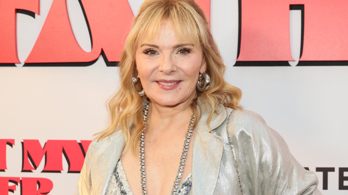 Close up of Kim Cattrall wearing silvery jacket on the red carpet