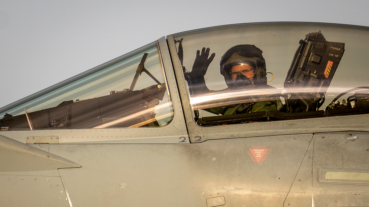 Airman waving in an aircraft