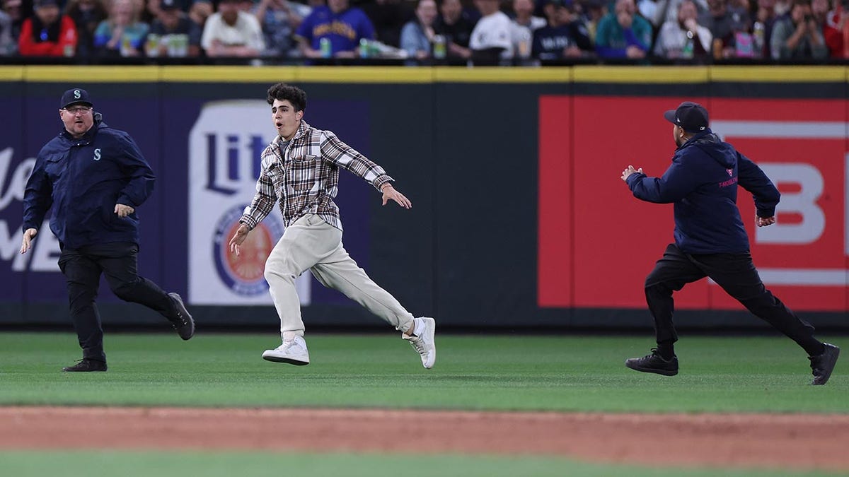 Fan runs on the field at Seattle's T-Mobile Park