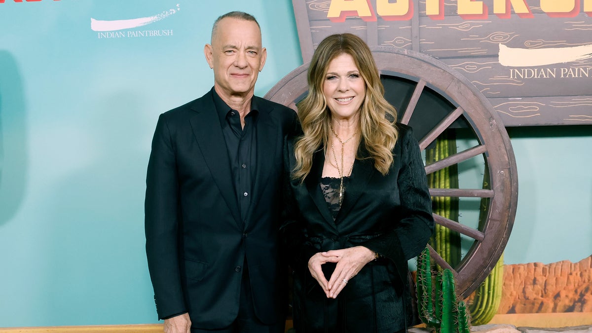 Tom Hanks in a black suit with Rita Wilson in a black pantsuit