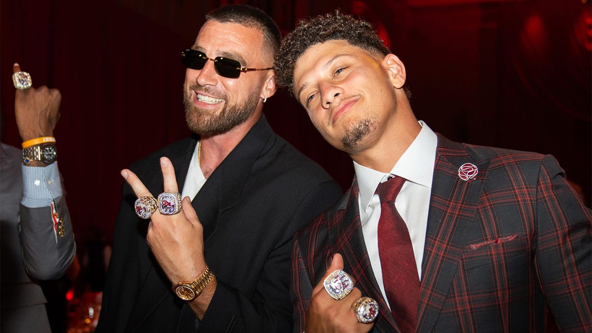 Travis Kelce and Pat Mahomes pose during their ring ceremony