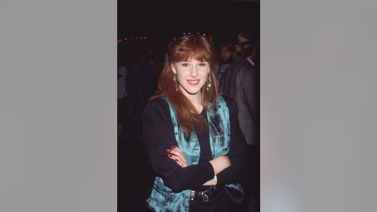 American pop singer Tiffany, wearing a black top and a blue vest in 1989
