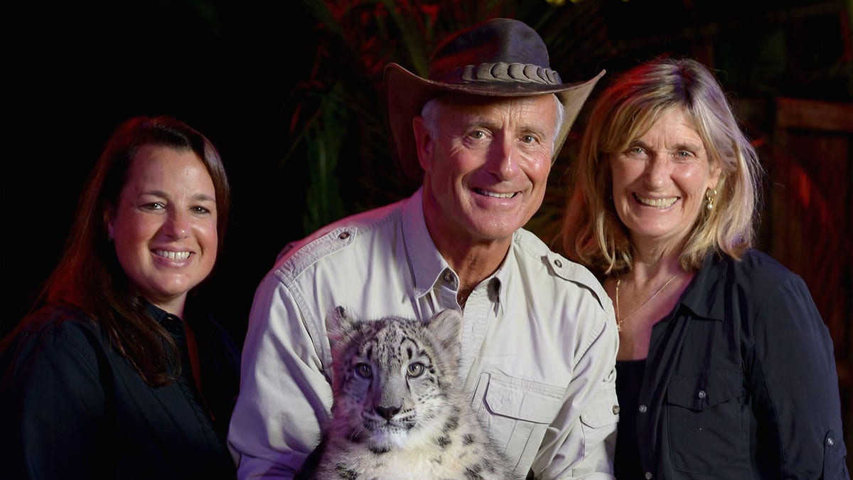 Jack Hanna poses with his wife, daughter and a snow leopard