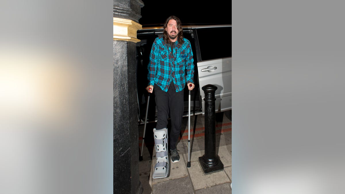 Dave Grohl walking with crutches