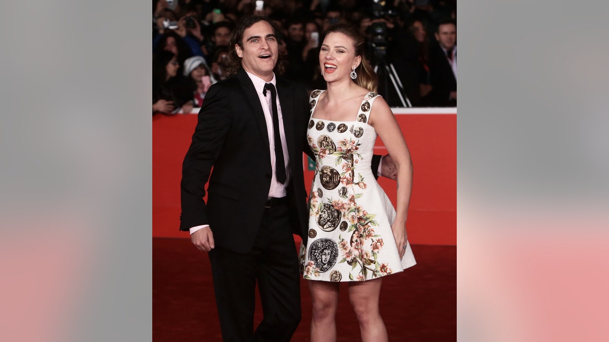 Joaquin Phoenix and Scarlett Johansson laugh on the red carpet for the premiere of "Her" in Rome