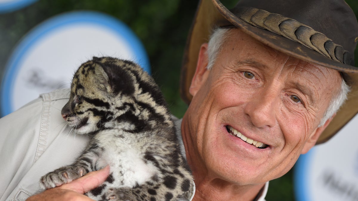 Jack Hanna poses with a snow leopard