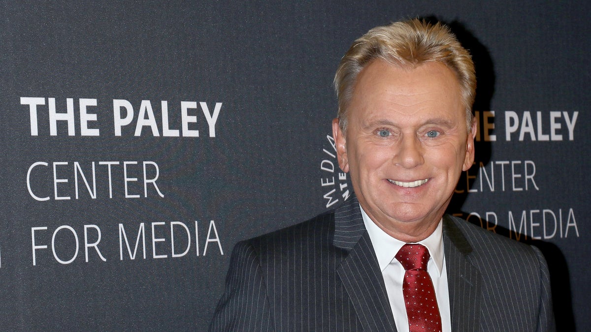 Pat Sajak in gray suit on red carpet