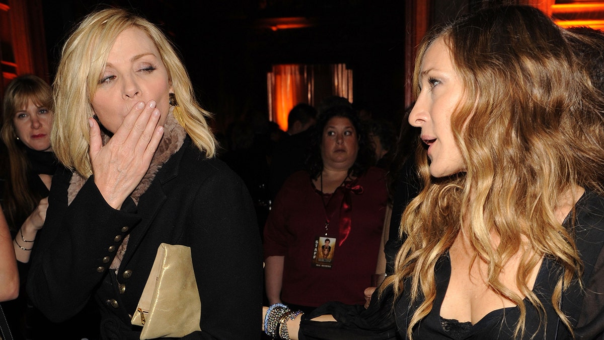 Kim Cattrall blows a kiss to a confused looking Sarah Jessica Parker at the premiere of Parker's film "Did You Hear About the Morgan?" after party