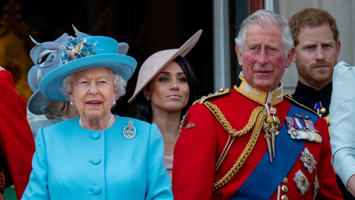 Queen Elizabeth II, King Charles III, Prince Harry, and Meghan Markle stand on the balcony for the Trooping of the Colour 2019