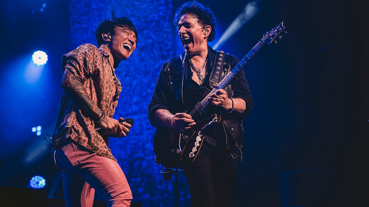 Arnel Pineda and Neal Schon performing on stage