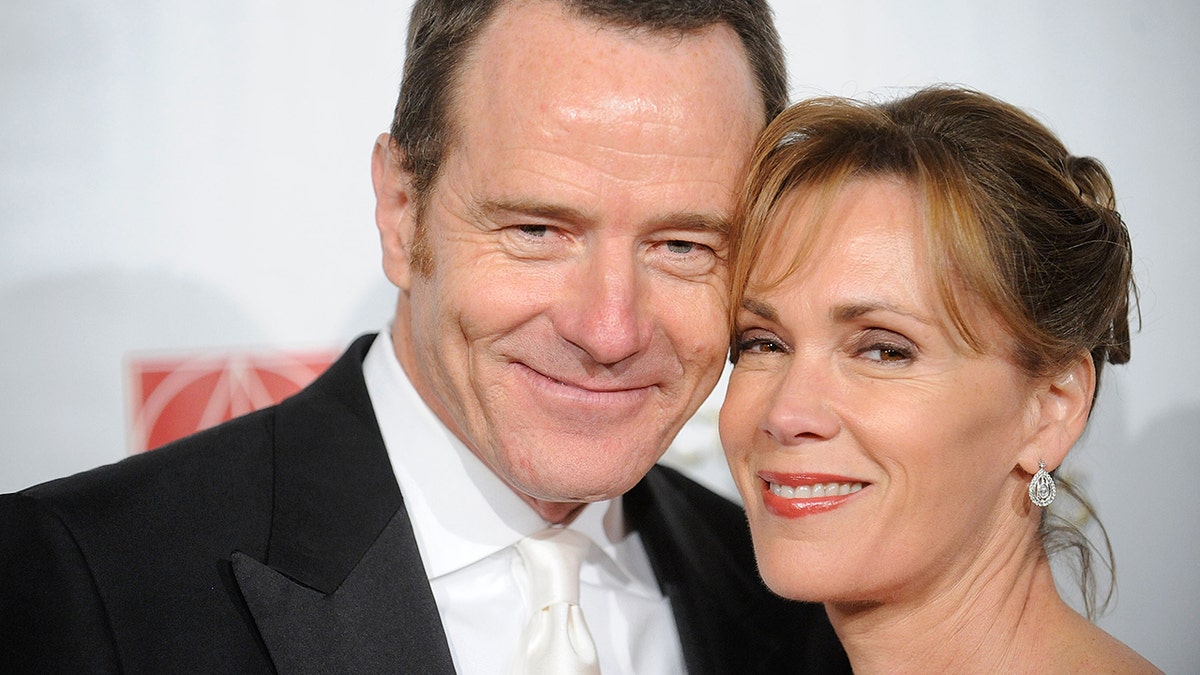 A close-up of Bryan Cranston canoodling with his wife Robin