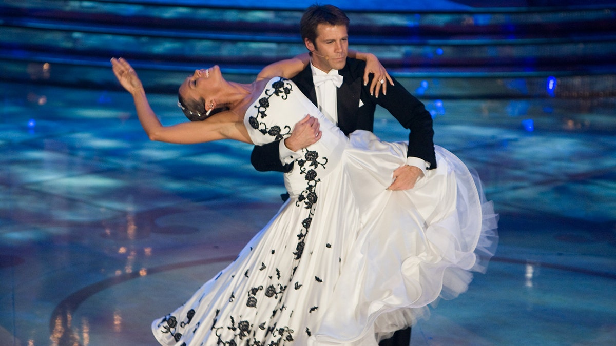 Emanuele Filiberto in a tuxedo holding a woman wearing a white ball gown